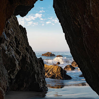 Wall Art featuring the photograph Ocean View Through The Rocks With Crashing Waves by Matthew DeGrushe
