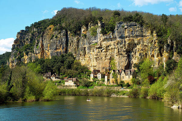 Architecture Photograph - Canoes Pass La Roque-Gageac On The Dordogne River #2 by Seeables Visual Arts