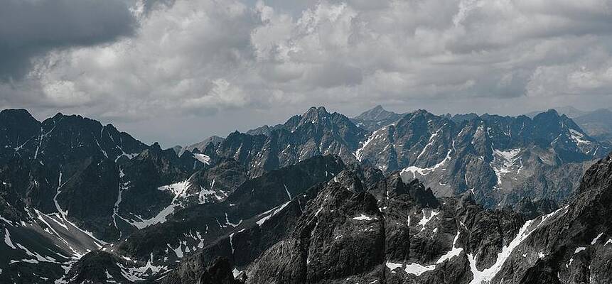 Majestic Mountain Range Under Clouds Photograph
