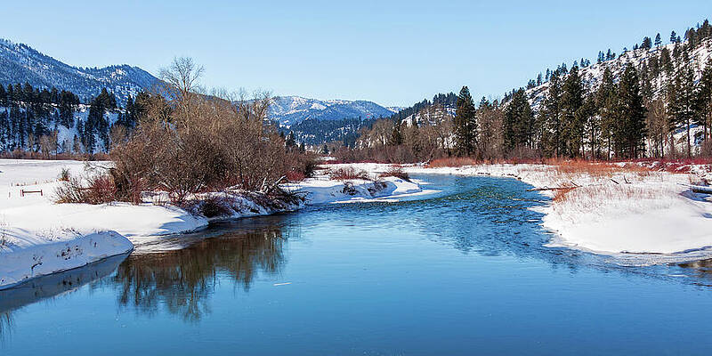 Wall Art featuring the photograph A Blue Mountain River In Montana At Wintertime by Tatiana Travelways