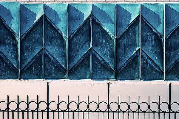 Wall Art featuring the photograph An Abstract Architectural Detail Featuring A Repeating Chevron Pattern On Oxidized Blue Metal Panels by Robert Niemeier