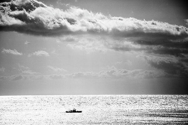 Solitary Boat Under Cloudy Sky Wall Art