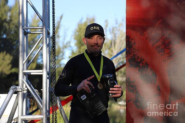 Athlete Holding Medal and Trophy Photograph