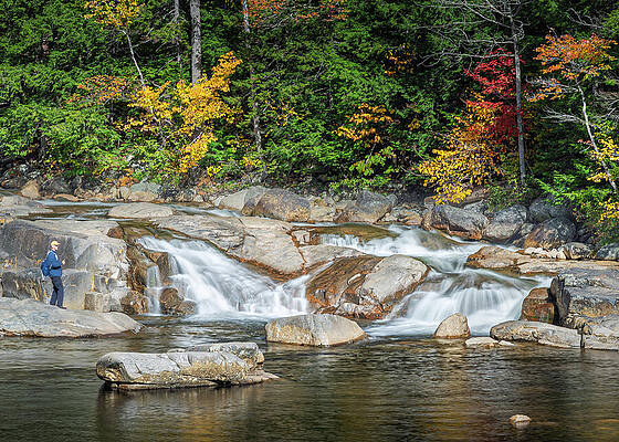 Person by Autumn Waterfall Photograph