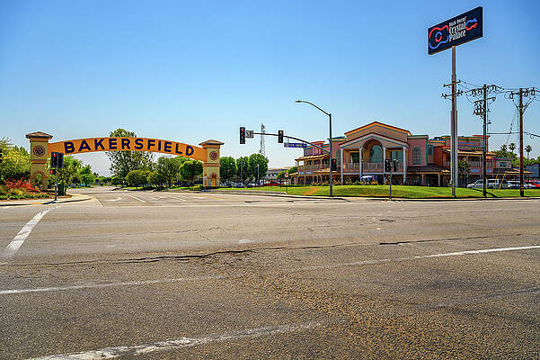 Landmark Wall Art featuring the photograph Bakersfield Arch Sign Over The Road On A Sunny Day With Clear Skies by Miroslav Liska