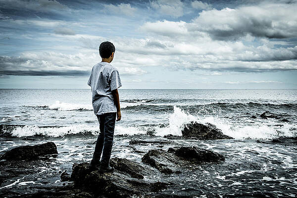 Sky Wall Art featuring the photograph Boy At The Edge Of The Sea by Francisco Ruiz Navas