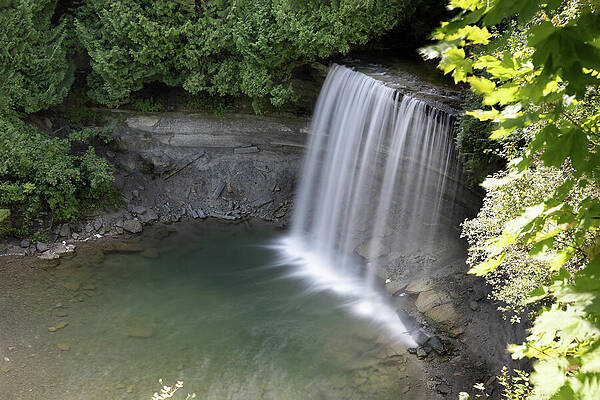 Serene Waterfall in Forest Photograph