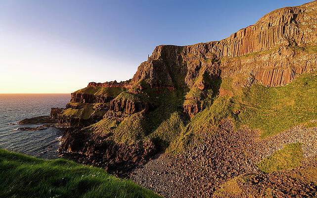 Sunlit Coastal Cliffs at Sunset Photograph