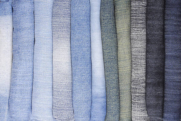 Photograph - Close Up Of The Stack Of Various Jeans by Severija Kirilovaite