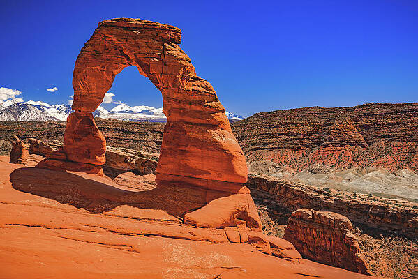 Color Photograph - Delicate Arch And Hills, Utah by Abbie Warnock
