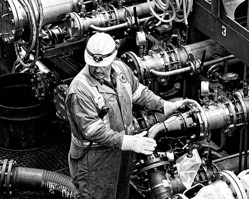 Textured Photograph - Fill 'er Up -- Workman Aboard A Fuel Tanker In Halifax, Nova Scotia by Darin Volpe
