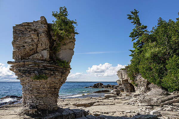 Rock Formation by the Shoreline Photograph