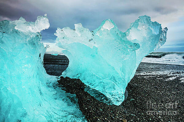 Dramatic Photograph - Icebergs On Jokulsarlon Black Beach, Iceland by Neale And Judith Clark
