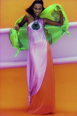 Orange Wall Art featuring the photograph Iman In Mary McFadden Silk Tunic, Skirt, And Scarf by Jacques Malignon