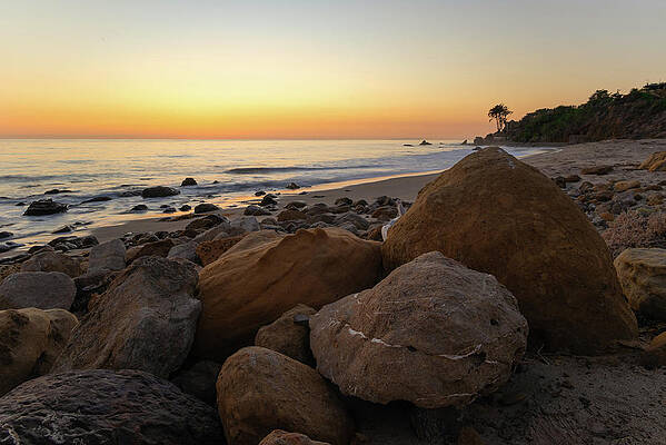 Wall Art featuring the photograph Large Rocks On The Beach After Sunset by Matthew DeGrushe