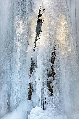 Frozen Waterfall Against Rock Face Photograph