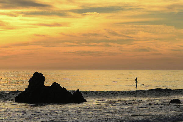 Wall Art featuring the photograph Lone Paddleboarder At Sunset by Matthew DeGrushe