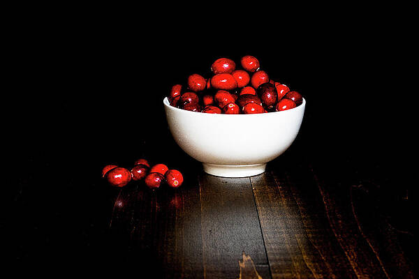 Colorful Photograph - Low Key Cranberries In White Porcelain Bowl On Brown Wood Base by Charles Floyd