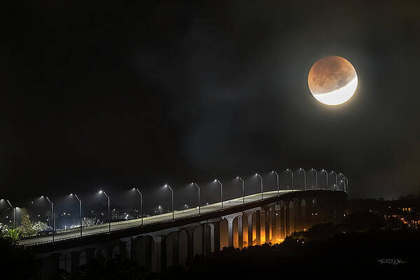 Lunar Eclipse Over Urban Bridge Photograph