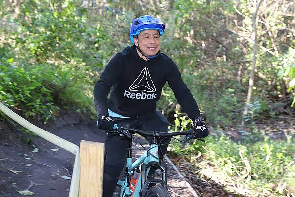 Man Biking Through Forest Trail Wall Art