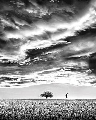 Man Running Under a Stormy Sky Photograph