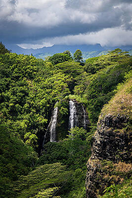 Wall Art featuring the photograph Opaekaa Falls Sunlit As Dark Storm Clouds Gather Over The Hills by Steven Heap