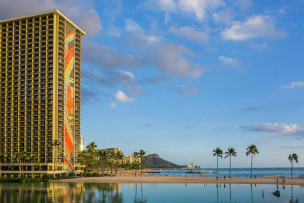 Tourism Wall Art featuring the photograph Rainbow Tower Frames The Shore In Waikiki Hawaii by Steven Heap