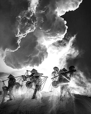Workers Against Dramatic Clouds Photograph