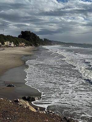 Serene Coastline on a Cloudy Day Photograph