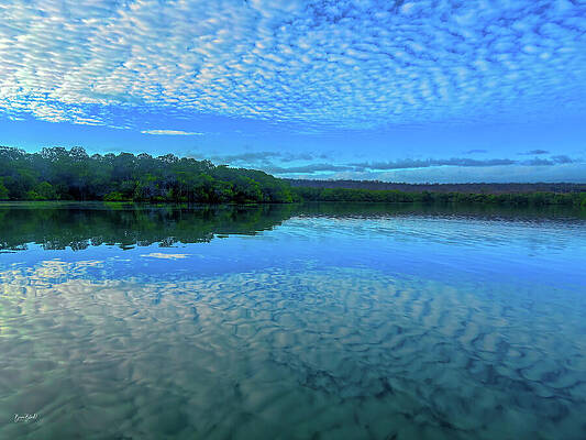 Serene Lake Under Patterned Sky Photograph