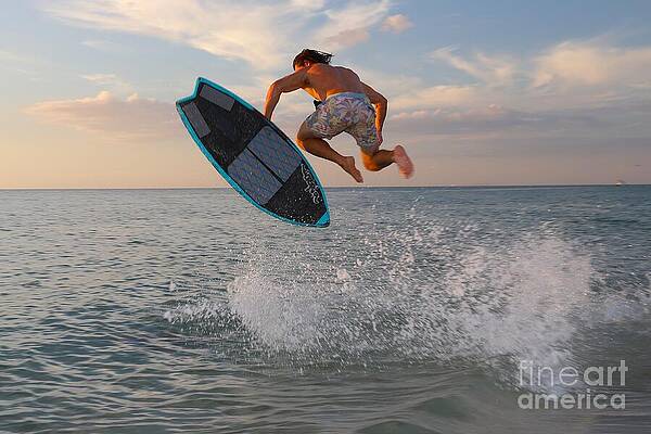 Skimboarder Mid-Air at Sunset Photograph