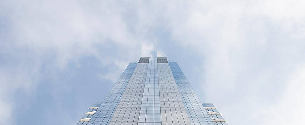 Skyscraper Against a Cloudy Sky Wall Art