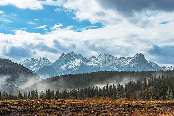 Snowy Mountain Range with Misty Forest Photograph