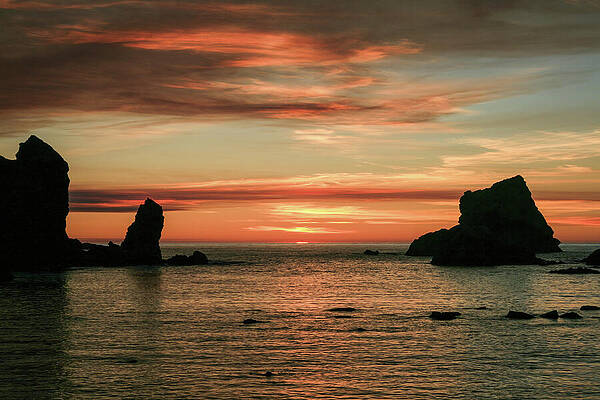 Dramatic Ocean Sunset with Rocks Photograph