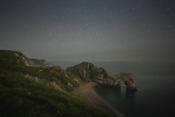 Dramatic Wall Art featuring the photograph Starry Night Sky Over Durdle Door by Charnwood Photography Fine Art