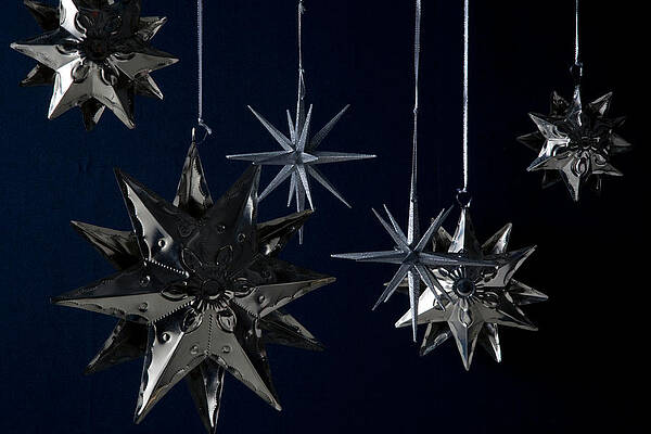 Hanging Metal Stars Against Dark Sky Wall Art