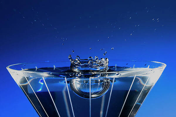 Artificial Light Wall Art featuring the photograph Stop Motion Martini Glass Blue Splash by Charles Floyd