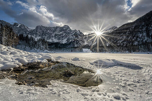 Winter Wall Art featuring the photograph Sunstar Reflections On Frozen Mountain Lake by Charnwood Photography Fine Art