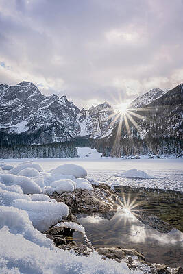 Winter Wall Art featuring the photograph Sunstar Reflections On Frozen Mountain Pool by Charnwood Photography Fine Art