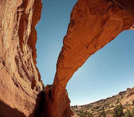 Majestic Rock Arch Against Blue Sky Photograph