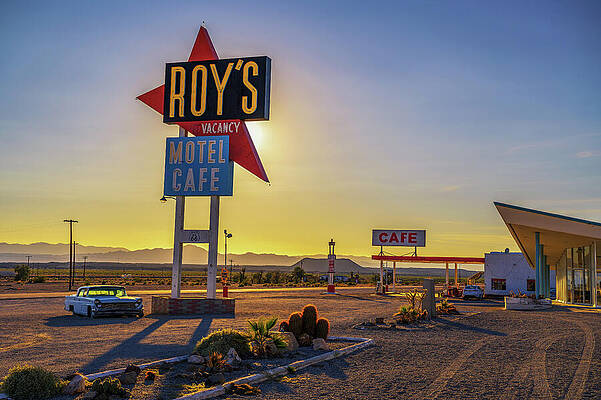 Vintage Wall Art featuring the photograph Vintage Neon Sign Of Roy's Motel And Cafe On Route 66 With Vintage Car by Miroslav Liska