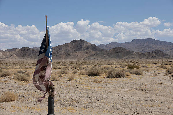 California Photograph - Weathered American Flag In Mojave Desert Landscape by John Twynam