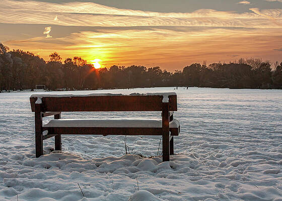 Sunset Over Snowy Park Bench Photograph