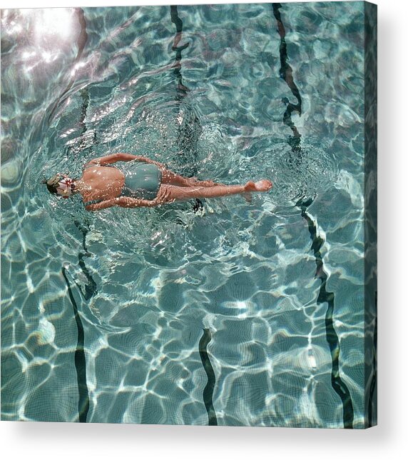 Woman Floating in Sunlit Pool Acrylic Print