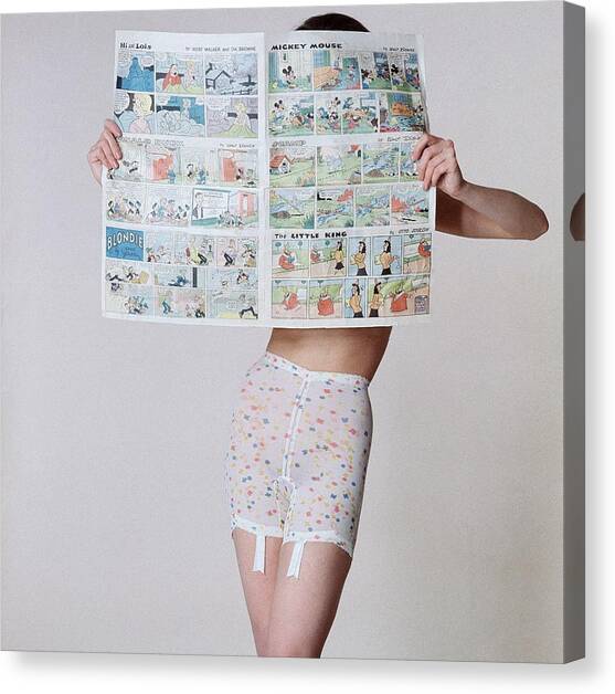 A Model Wearing A Girdle With A Comic Canvas Art Print by Louis Faurer
