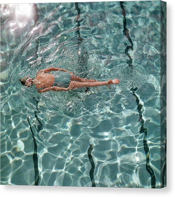 A Woman Swimming In A Pool Canvas Art Print by Fred Lyon