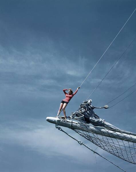 Woman Poses on Sailboat Bow Poster