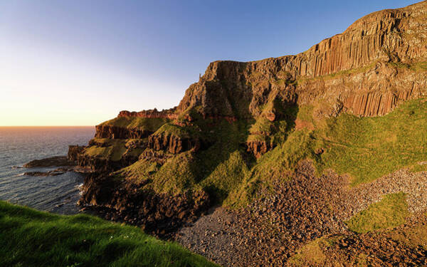 Sunlit Coastal Cliffs at Sunset Poster