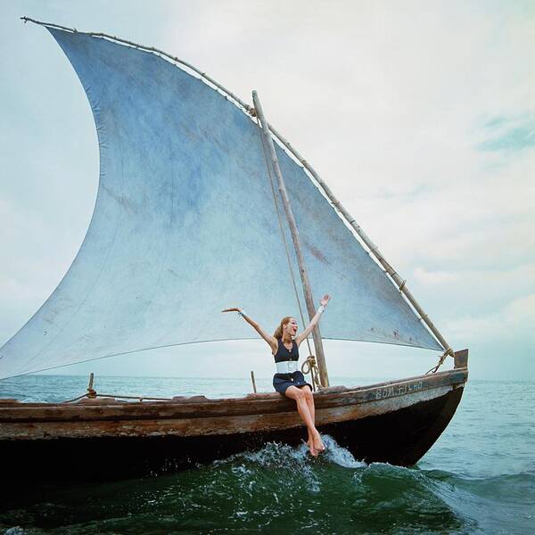 Woman Sailing on a Traditional Boat Poster