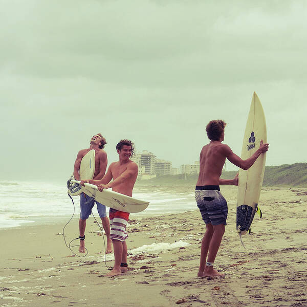 Surfers on a Cloudy Beach Poster